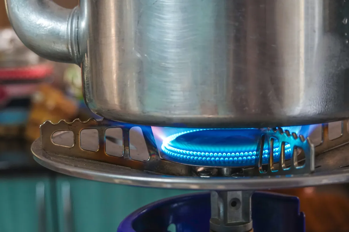 Natural gas burner heating a stainless steel kettle — residential gas appliance installation by D&S Utility Services